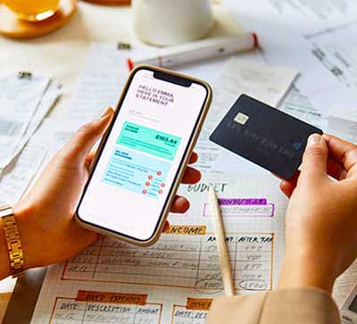person paying bills online with card